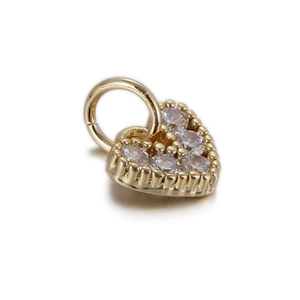 Detailed view of a gold heart charm pendant featuring five sparkling cubic zirconia stones
