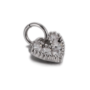 Macro view of heart-shaped silver pendant with five cubic zirconia stones and ring clasp