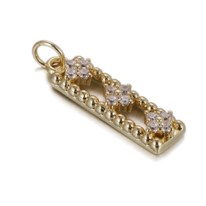 Macro detail of gold-plated rectangular pendant with zircon stone cluster and beaded edges