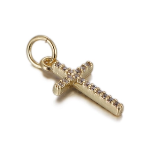 Macro detail of gold cross pendant with micro-pave cubic zirconia and top hanging ring