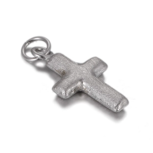 Macro view of vintage silver cross pendant with textured finish and durable jump ring