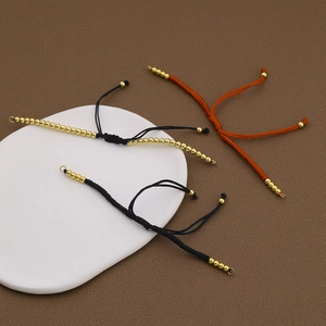 Handgewebte Armbänder in Schwarz und Orange mit Goldperlen und verstellbarem Zugknoten