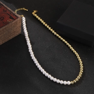 French vintage style pearl necklace with gold bead stitching and butterfly pendant