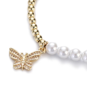 Close-up of a French vintage pearl bracelet featuring a sparkling crystal butterfly charm