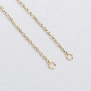 Close-up of golden circular link chain component with O-rings for jewelry assembly