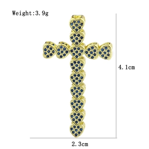 Macro view of gold heart cross pendant with blue zircons showing precise size measurements