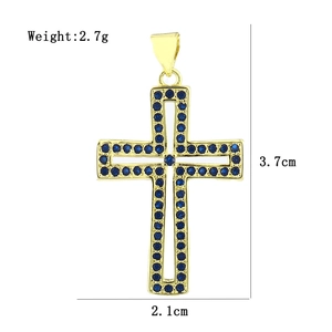 Macro shot of gold cross pendant with blue zircon stones and dimensional measurements