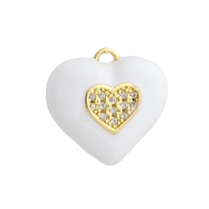 Macro shot of white enamel heart pendant with micro-set zircons and golden core detail