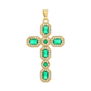 Macro shot of gold-plated cross pendant with emerald green zircons and white pave stones