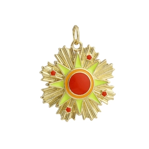 Close-up of 18k gold-plated sun star tarot pendant with red and green enamel inlay