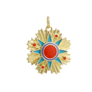 Macro shot of 18k gold plated sunburst tarot pendant with red enamel and star details