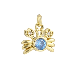 Detail of 18k gold plated crab charm with blue gemstone and sparkling crystal eyes