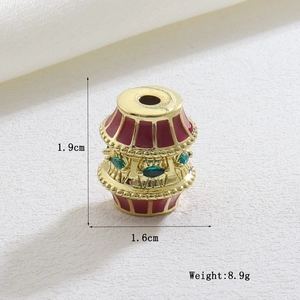 Detailed macro view of luxury geometric copper charm with red enamel and green stones