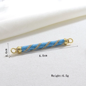 Macro detail of 6cm blue enamel cylinder bead with spiral texture and crystal inlays
