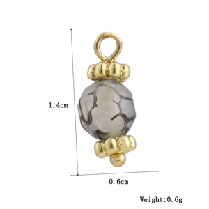 Macro detail of a 1.4cm grey agate bead pendant with 18k gold plated metal spacer beads