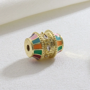 Detailed view of colorful enamel barrel charm with sparkling zircon inlay for DIY bracelets
