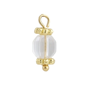 Macro shot of 18k gold plated pendant with multifaceted clear stone and floral metal spacers