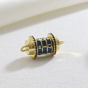 Macro detail of gold cylinder pendant with navy enamel, gold stars and pavé crystals