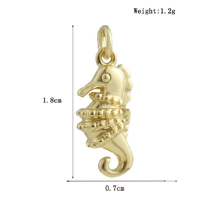 Detailed 18k gold plated seahorse pendant showing bead texture and 1.8cm scale