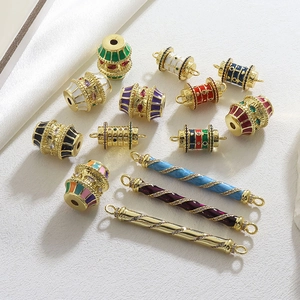 Macro shot of colorful enamel barrel beads and gold-plated connectors with zircon micro-pave