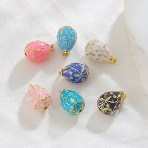 Detail of Fabergé style egg pendants with enamel floral patterns and zircon inlays
