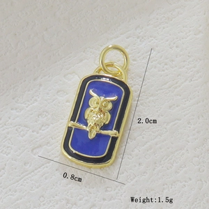 Detail view of a 2.0x0.8cm blue enamel owl pendant with golden 18k plating and 1.5g weight