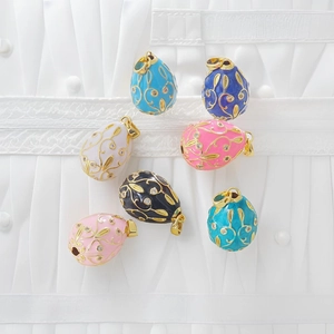 Detail of Faberge-style colorful enamel egg pendants with 18k gold plating and crystals