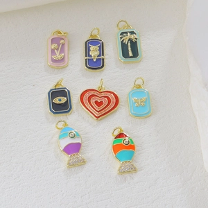 Detailed macro shot of 18k gold plated enamel castle pendants with zircon inlays