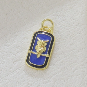 18k gold plated castle owl pendant with royal blue enamel on textured background