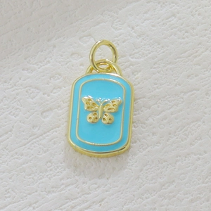Detail of light blue enamel butterfly pendant with vintage gold relief design