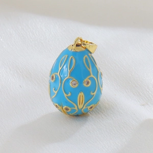 Detail of 18k gold plated sky blue enamel egg pendant with crystals on white silk