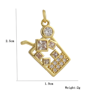 Macro detail of 18k gold plated drink cup pendant with sparkling zircon inlays