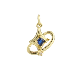 Detail of gold star pendant featuring a blue square gemstone and orbital ring design
