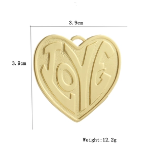 Macro view of 18k gold heart pendant featuring LOVE engraving and size dimensions
