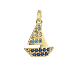 Close-up of golden sailboat pendant with blue zircon stones and detailed craftsmanship