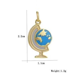 Macro shot of 18k gold plated globe pendant with dimensions 2.2cm and 1.2g weight