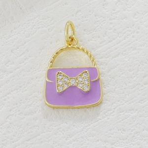 Macro shot of 18k gold plated purple enamel handbag charm with zircon bowknot detail