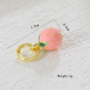 Macro shot of 1.3cm pink enamel strawberry pendant with green leaf and golden ring loop