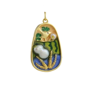Detail of 18k gold plated oval charm with bird and enamel floral patterns
