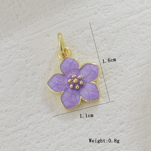 Macro detail of a 1.6cm purple cherry blossom pendant with gold trim and size annotations