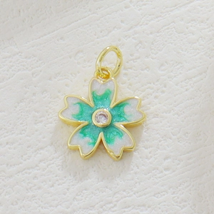 Golden cherry blossom pendant with white glitter petals, green enamel, and zircon center