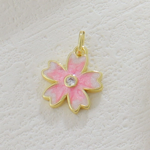 Detailed view of pink cherry blossom pendant with golden edges and zircon center