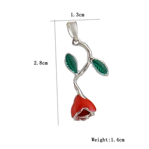 Detail view of 18k gold plated cactus flower pendant with red enamel rose and green leaf