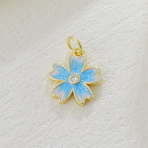 Macro shot of cherry blossom pendant with blue enamel and sparkling cubic zirconia