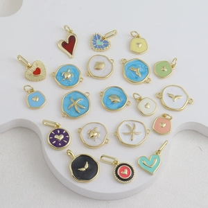 Close-up of assorted enamel marine pendants with gold plating for DIY jewelry making
