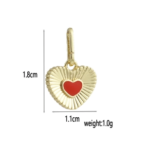 Detailed view of 18k gold heart pendant with red enamel inlay and size measurements