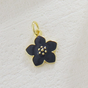 Detail of cherry blossom pendant with black enamel finish and gold plated border