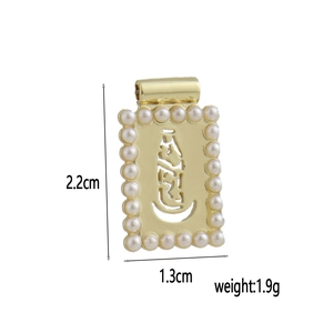 Macro view of 18k gold plated rectangular pendant with pearls and center portrait