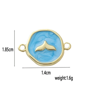 Detailed view of 18k gold plated blue enamel whale tail charm with size measurements