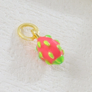 Macro shot of 18k gold plated dragon fruit pendant with vibrant enamel finish